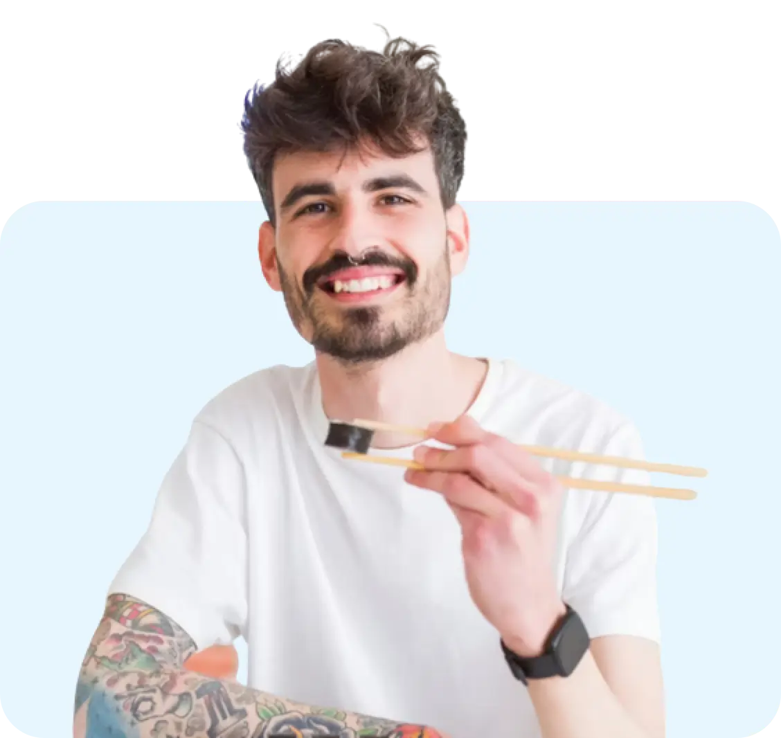 Young man eating small portion with chopsticks